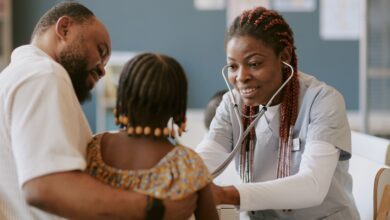 Nurse checking child's health with stethoscope