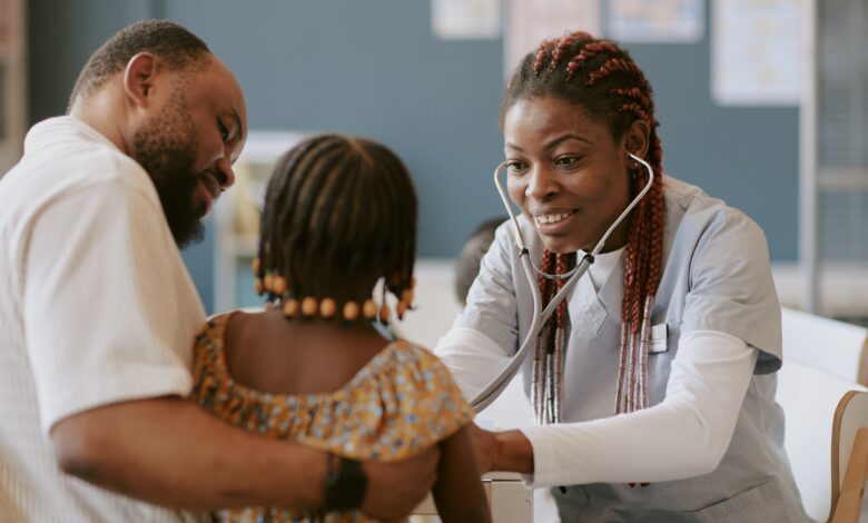 Nurse checking child's health with stethoscope